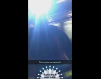 Construction worker at a subway stares at a person wearing trashbags as clothes