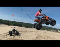 Red shirt guy jumps ATV success sand 