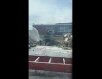 Time lapse school building demolished by truck