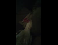 Man talks and chicken next to him at the bed