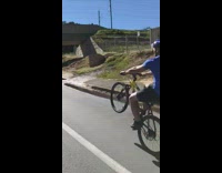 Blue shirt guy wheelie bike helmet falls on street