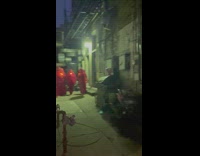 Group of hooded people in alley way 