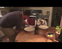 Two dogs sit at dinner table for a picture