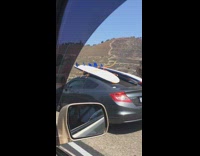 Collab Kook Of The Day - Two surfboards tied to roof grey car 