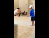 Little boy does variety golf trick chip shots inside home
