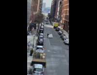 Guy raise white umbrella wings middle street