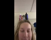 Cat in shower with owner in hanging basket 