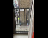 Man takes picture holding brick wall