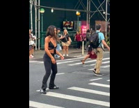 Lady on Crosswalk Does Stretches as People Cross