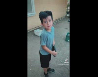 Guy pretends to take picture of little boy new haircut 