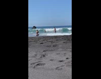 Black bikini girl photographs blue shorts guy