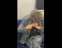 Man in train burn chest hair with lighter