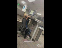Person working while sitting in chair under desk 