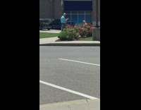 Bald guy older lady bench rose bush 