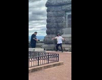 Man dances in front of a monument 