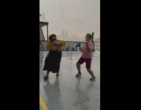 People dance and cheer on rainy day ferry
