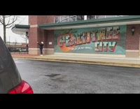 	
Woman takes photo in front of Georgia Peach sign