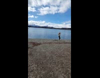 Woman white jacket tiktok dance at river