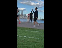 Girl cap white top jog cameraman follow