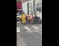 Yellow apron guy unloads raw meat cart 