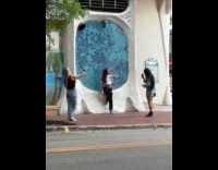 Three women different photoshoot on the sidewalk