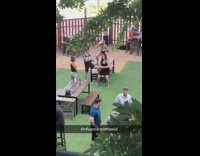 Four women dance tiktok public park