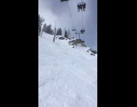 Collab JerrySlams - Skier jumps off rock in front of ski lift, lands then spins out of control down slope