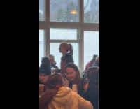 Two people dances outside the ski cabin