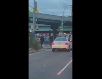 Man rides bike on street with a tire 