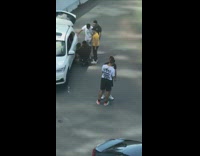 Guy sit call while friends fix wheel