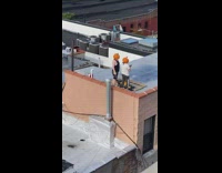 Two people wearing carved pumpkins over their heads take selfie