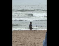 Man tiktok dance with tripod at beach