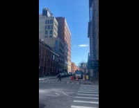 Workers move down hanging object from rooftop
