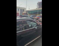 Man carry appliance above his head rides his bike 