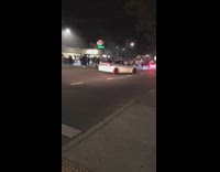 People gather middle of street car meet