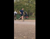 Guy ride bike hit green dumpster park