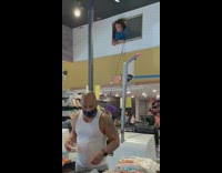 Lady takes bag with bucket and pulley system 