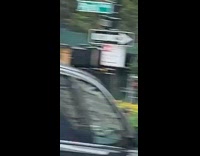 Guy pull ups black pedestrian crossing light