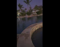 Guy paddles around pool on surfboard