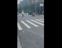 Woman playing trumpet while another guy in animal mask parades
