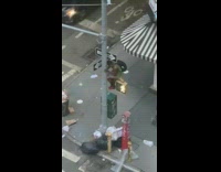 Guy sits pedestrian light scares people walking