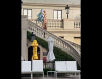 Woman bikini hold cloth stand beside railings