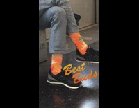 2 passengers on train wear weed socks 