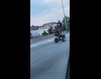 Black shirt guy wheelie red ATV freeway 