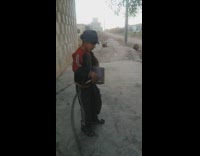 Kid sprays metal tin can bucket hat