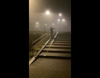 Man stands and slides on the slippery stairway