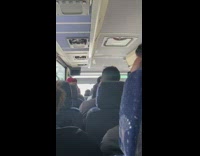 Guy selfie vlogging on bus