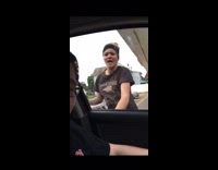 Girl bangs on car window cigarette friend 