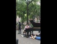 Man plays grand piano in park people sleep