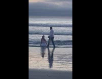 Woman white dress sit beach water wig